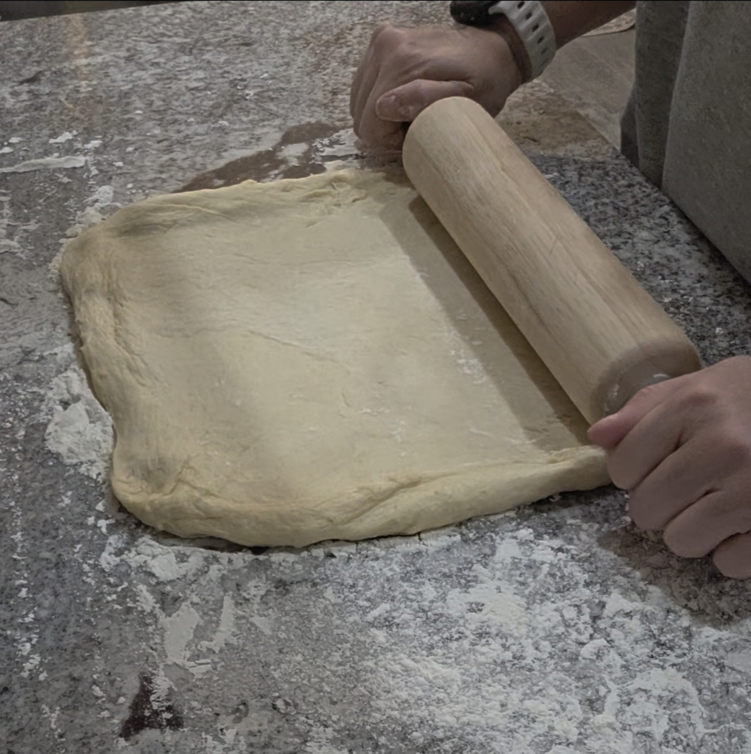 Brandy rolling cinnamon roll dough by hand
